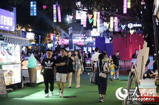 2024年6月14日，在廣東佛山創意產業園，舊廠房蝶變國家級夜市，夜幕下的園區燈火輝煌，人潮涌動。游客們在此流連忘返，享受著淘寶的樂趣。人民網 何善福攝